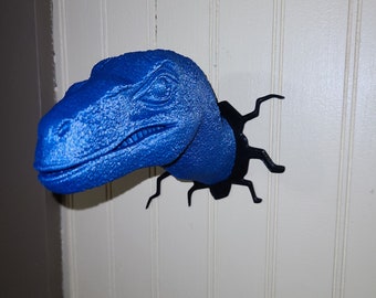 Blue velociraptor breaking through wall