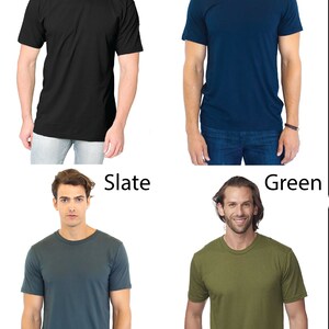 May include: Four men's t-shirts in different colors: black, navy, slate, and green. The shirts are all crew neck and short-sleeved.
