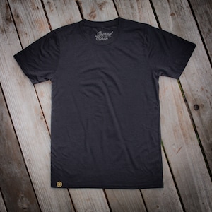 May include: A black t-shirt with a small gold logo that says "Sacred State" on the front.