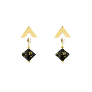 May include: A pair of gold earrings with black and gold geometric pendants. The earrings have a triangular top and a dangling geometric shape.