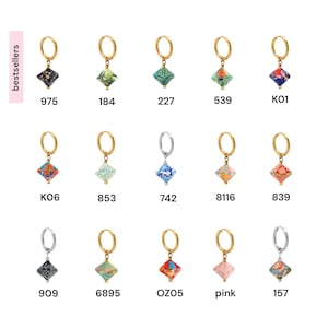 May include: A collection of 12 gold and silver hoop earrings with colorful, geometric, patterned charms. The charms are made of paper and have a variety of designs, including floral, abstract, and geometric patterns.