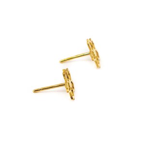 May include: A pair of gold-toned flower-shaped stud earrings.