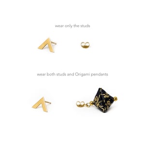May include: Two pairs of earrings, one with a gold triangle stud and the other with a gold triangle stud and a black origami pendant with gold accents. The text "wear only the studs" and "wear both studs and Origami pendants" is shown above the earrings.