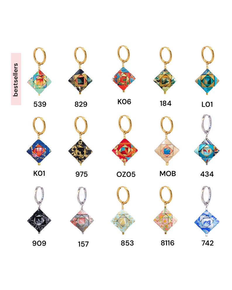 May include: Assortment of 10 gold and silver hoop earrings with colorful patterned charms. The charms are square-shaped and feature a variety of geometric designs and colors.