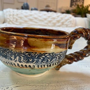 Handmade pottery ceramic mug with braided handle