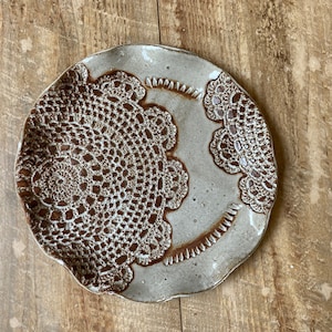 Handmade pottery white plate with doilie