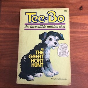 May include: A book cover featuring a cartoon dog with the title "Tee-Bo the incredible talking dog" and the words "In the Great Hort Hunt" in yellow letters.