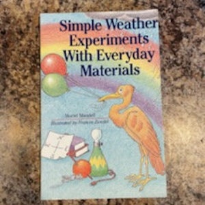 May include: A book titled "Simple Weather Experiments With Everyday Materials" with a colorful illustration of a bird, balloons, and other objects.