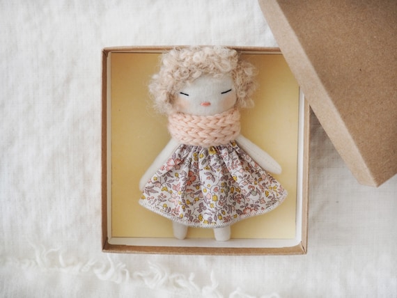 Micro miniature pocket doll in a kraft and floral box