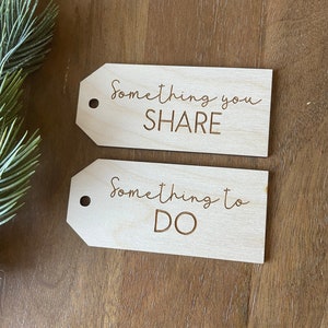 May include: Two wooden gift tags with the text "Something you SHARE" and "Something to DO" written on them.