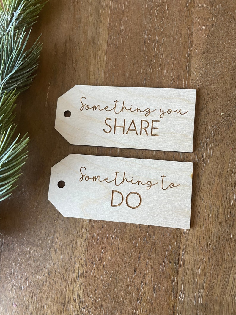 May include: Two wooden gift tags with the text "Something you SHARE" and "Something to DO" written on them.