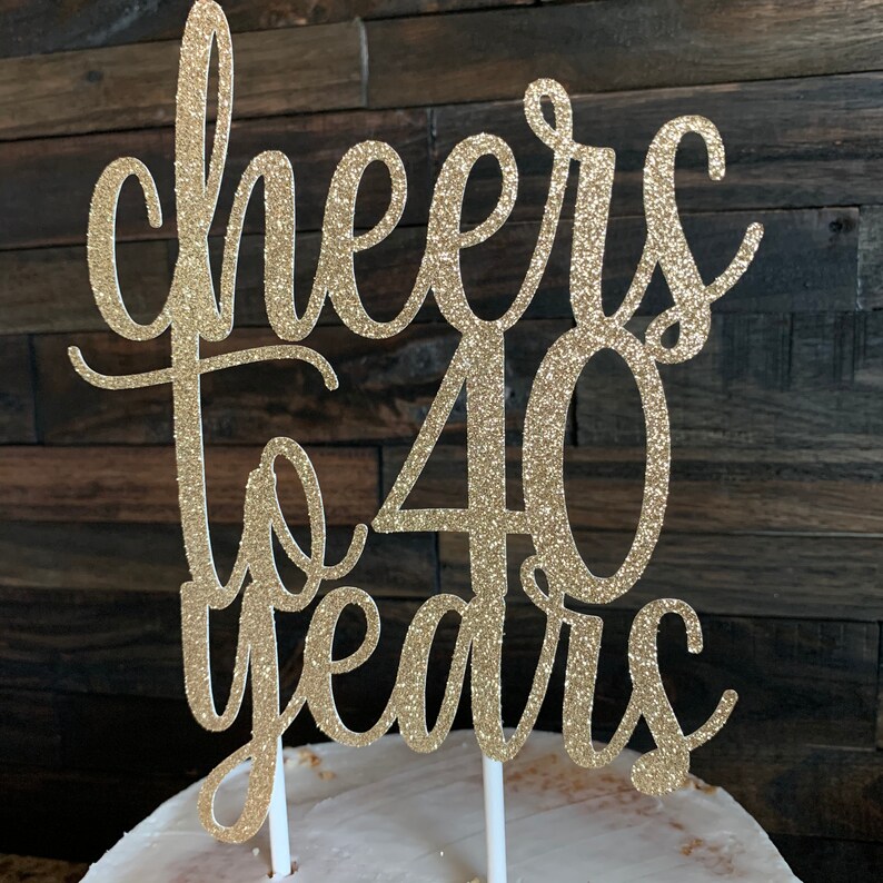 May include: Gold glitter cake topper with the text "Cheers to 40 years".