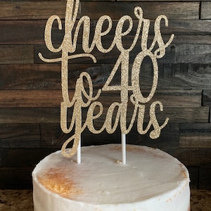 May include: Gold glitter cake topper with the text "Cheers to 40 years".