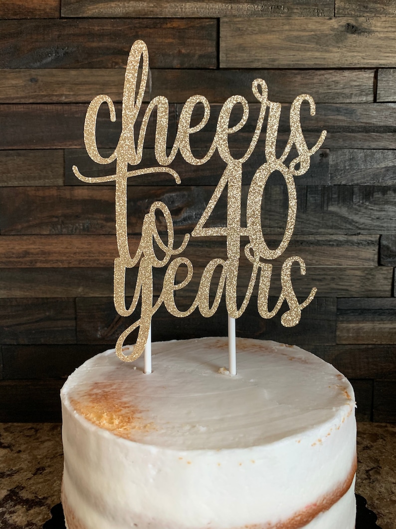 May include: Gold glitter cake topper with the text "Cheers to 40 years".