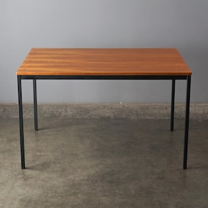 May include: A rectangular wooden table with a reddish-brown top and black metal legs. The table is approximately 30 inches long, 20 inches wide, and 28 inches high. The design is minimalist and modern, suitable for various interior styles.