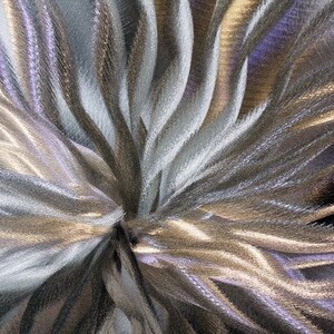May include: Abstract background with a swirling pattern of silver and gold metallic lines.