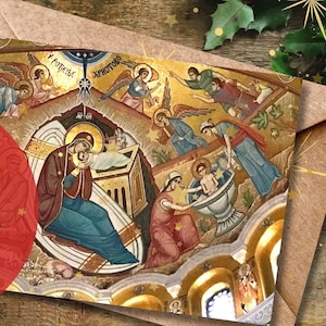 May include: A digital download of a Christmas card featuring a traditional Byzantine icon of the Nativity of Jesus. The card is surrounded by green pine branches and red berries.