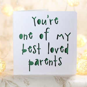 May include: A white card with the text "You're one of my best loved parents" written in green.