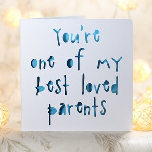 May include: A white card with blue lettering that reads "You're one of my best loved parents".