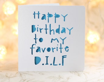 May include: White card with blue lettering that reads "Happy birthday to my favorite D.I.L.F."