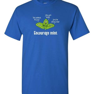 A bright royal blue t-shirt displaying an illustration of smiling mint leaves and the text Encourage mint.