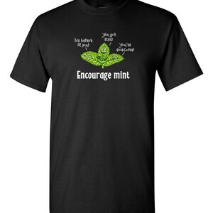 A black t-shirt displayed flat featuring an illustration of smiling mint leaves and the text Encourage mint.