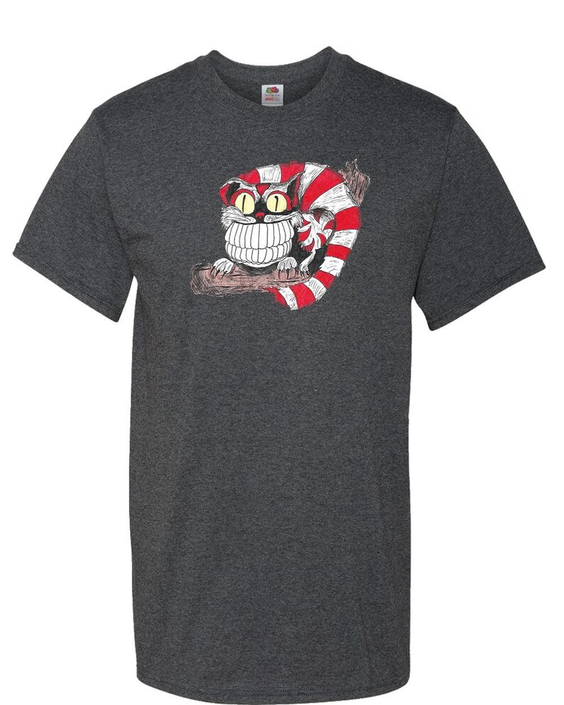May include: A dark heather grey t-shirt with a cartoon Cheshire Cat graphic. The cat is red and white striped and has a large grin with sharp teeth.