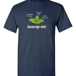 A dark navy blue t-shirt with a graphic of cartoon mint leaves and the text Encourage mint.