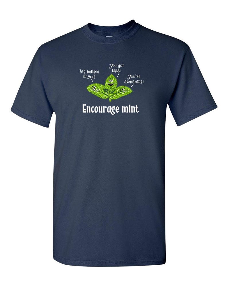 A dark navy blue t-shirt with a graphic of cartoon mint leaves and the text Encourage mint.