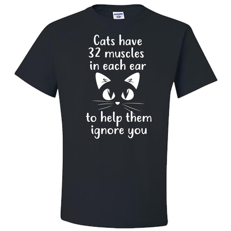 May include: Black t-shirt with a white cat illustration and the text "Cats have 32 muscles in each ear to help them ignore you."