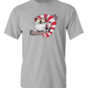 May include: A gray t-shirt with a cartoon illustration of a Cheshire Cat with a wide grin and red and white stripes. The cat is sitting on a branch.