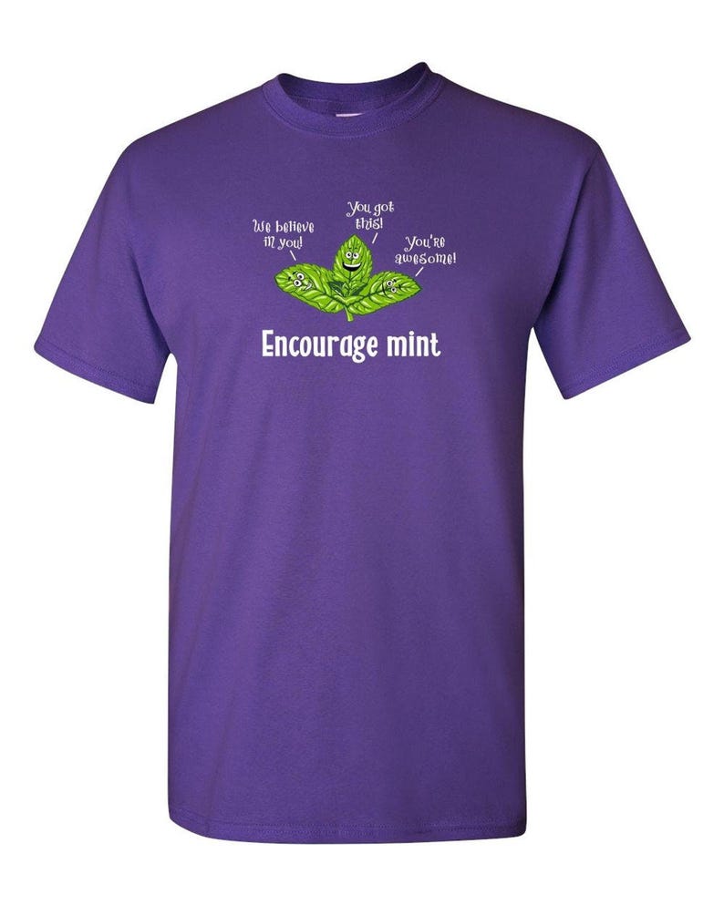 A purple t-shirt featuring a graphic of cartoon mint leaves and the text Encourage mint.