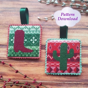 May include: Two square Christmas ornaments with a red boot and a green cactus on a wood background. The ornaments have a green, red, and white patterned design. The text "Pattern Download" is in a white cloud shape.
