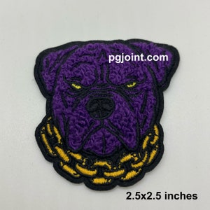 May include: Purple embroidered patch of a dog's face with a gold chain around its neck. The patch is 2.5x2.5 inches and has the text "pgjoint.com" on it.