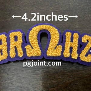 May include: A purple and gold embroidered patch with the word "BRΩHZ" in a varsity style. The patch is 4.2 inches wide and 1.4 inches tall. The website pgjoint.com is printed below the letters.