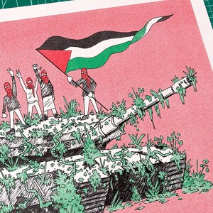 May include: Illustration of a tank covered in green foliage, with figures holding a Palestinian flag. The figures are wearing red face coverings and standing on the tank. The background is a solid pink color.