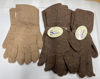 Könnte beinhalten: Drei Paar gestrickte Handschuhe in Brauntönen. Ein Paar ist hellbraun, die anderen beiden Paare sind dunkler braun. Jedes Paar hat ein Etikett mit der Aufschrift "North American Alpaca Certified Sorted Fiber Producers."