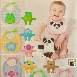 May include: Simplicity pattern featuring baby bibs and plush toys. The bibs have animal designs, including a frog, panda, monkey, dog, and bear. The toys match the bib designs. The pattern is labeled "Bradley 1904 OS".