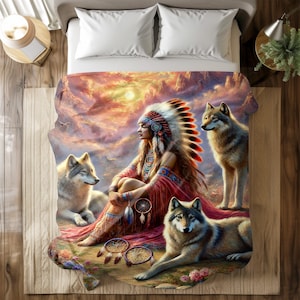 May include: A Native American woman wearing a headdress sits with three wolves in a colorful landscape. The woman is holding a dreamcatcher and the wolves are looking at her. The background is a sunset with clouds and mountains.