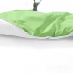 a bed with a green and white comforter