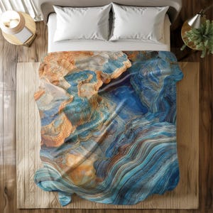 May include: A blue and orange abstract bedding set with a swirling pattern reminiscent of rock formations.