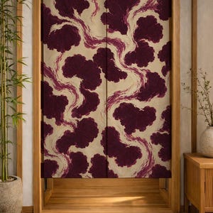 May include: A Japanese noren curtain featuring a cream backdrop with a repeating pattern of dark burgundy cloud-like shapes and flowing lines in a lighter burgundy hue. The curtain is in a wooden doorway.