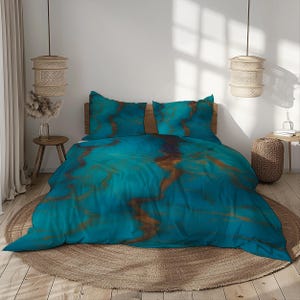 May include: A teal and copper-coloured bedding set with a marbled design. The set includes a duvet cover and two pillowcases. The bedding is displayed on a wooden bed frame, with a round woven rug underneath.