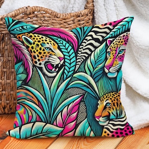 May include: A colorful throw pillow with a jungle theme featuring three leopards in a vibrant tropical leaf pattern. The pillow is a mix of pink, blue, green, yellow, and black.