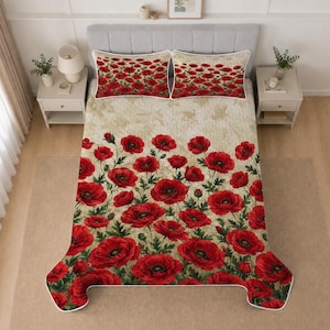 May include: A quilted bedspread and two matching pillow shams featuring a vibrant red poppy flower pattern on a textured, beige, vintage-style background. The floral design is concentrated at the bottom of the bedspread and across the pillows.
