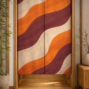 May include: A decorative door curtain with a retro wave pattern in shades of orange, burgundy, and cream. The curtain hangs in a wooden doorway, creating a warm and inviting aesthetic. The design is reminiscent of mid-century modern decor.
