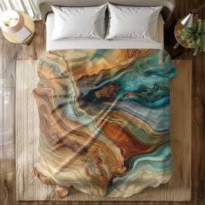 May include: A duvet cover with an abstract design featuring swirling patterns of brown, gold, blue, and green. The design resembles agate or marble.
