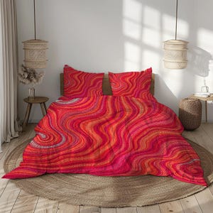 May include: A bedding set comprising a duvet cover and two matching pillowcases, decorated with a vibrant, wavy pattern in shades of red, orange and pink. The fabric features a continuous, flowing design of undulating lines creating a dynamic effect.