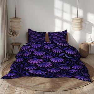 May include: Bedding set with a dark background and a repeating floral pattern in purple hues. The design features stylized flowers, leaves, stars, and crescent moons. The set includes a duvet cover and two pillowcases.