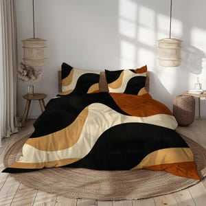 May include: A bed dressed with a duvet cover and two pillowcases. The bedding has a wavy design in black, tan, cream, and rust-orange. The bed sits on a round, woven rug. Two woven pendant lights hang above the bed.